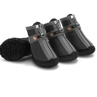 Set of four gray and black dog boots on a white background